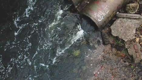 streams of water flow through concrete sewers. polluted body of water in the park. shooting with a drone by turning the camera down.