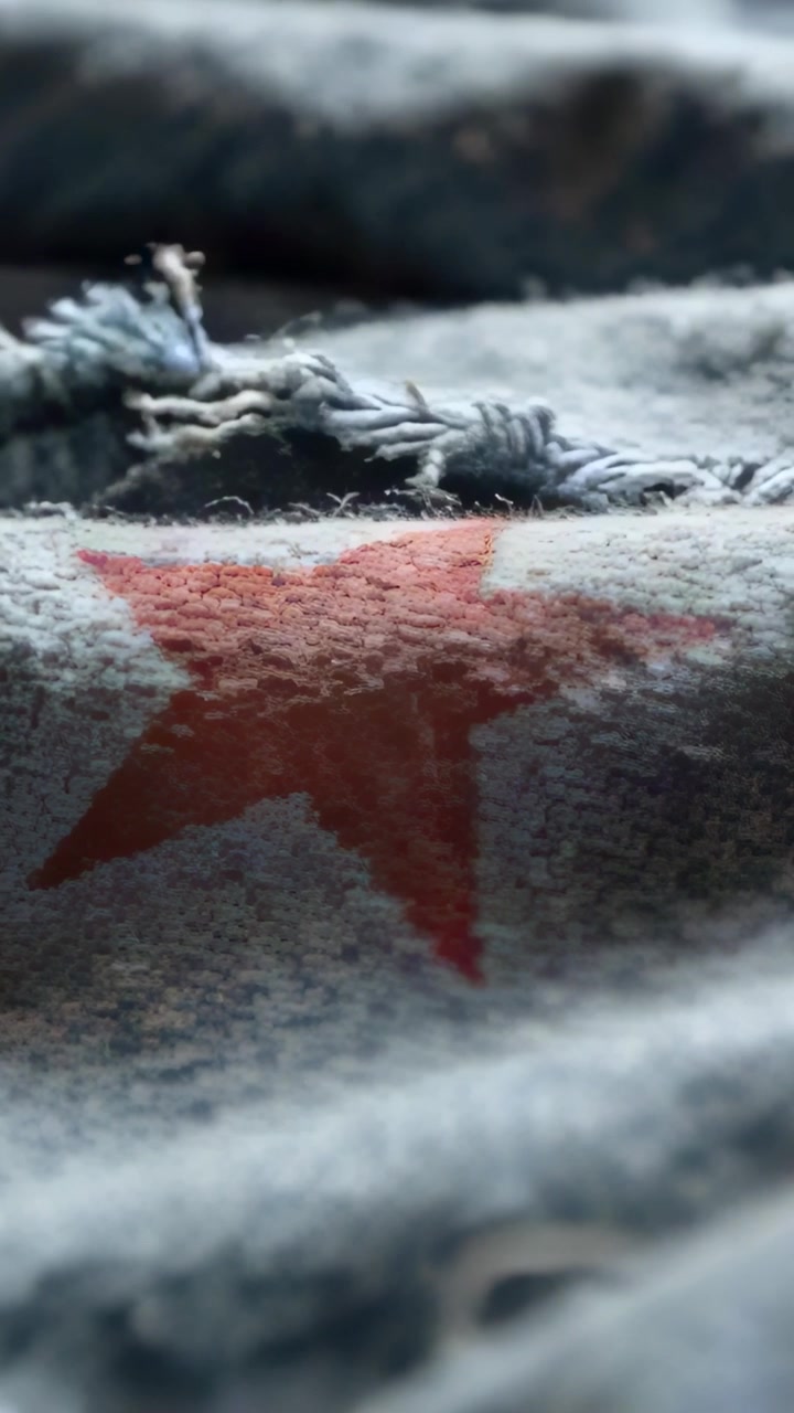 Vertical video: Pulling focus, camera revealing star on blue bed fabric, frayed trim and eyelet