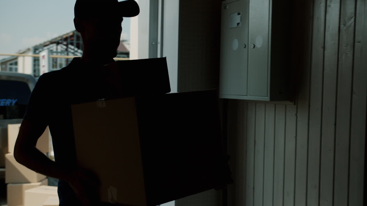 Delivery Person with Cardboard Boxes