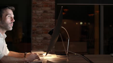 satisfied man in his office at night