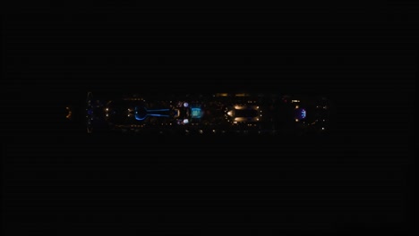 Aerial-top-down-descending-shot-over-a-cruise-ship-at-night-time