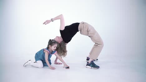 mother and daughter doing yoga and acrobatics