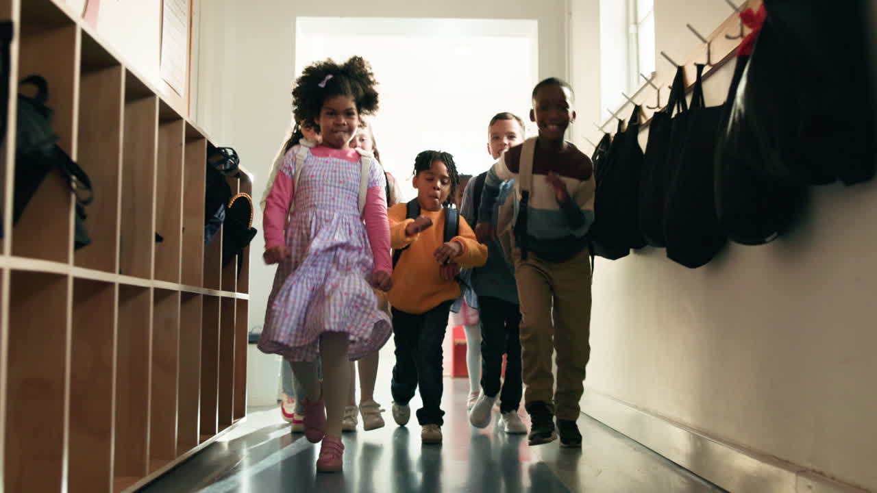 Excited students running in a school hallway