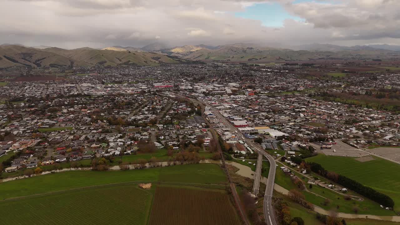 Blenheim cityscape and surrounding vineyards, town with hills in background, Marlborough, New Zealand. Aerial drone panoramic view