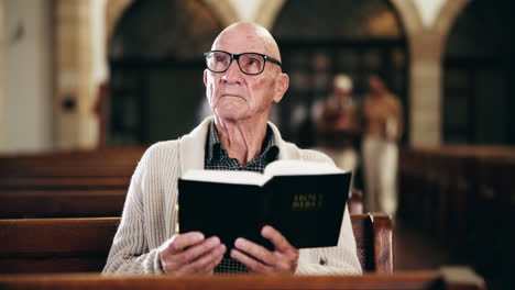elderly man reading bible in church