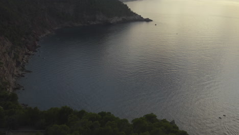 La-Inclinación-Aérea-Revela-El-Horizonte-Brumoso-Al-Atardecer-En-La-Escarpada-Costa-De-Mallorca,-España