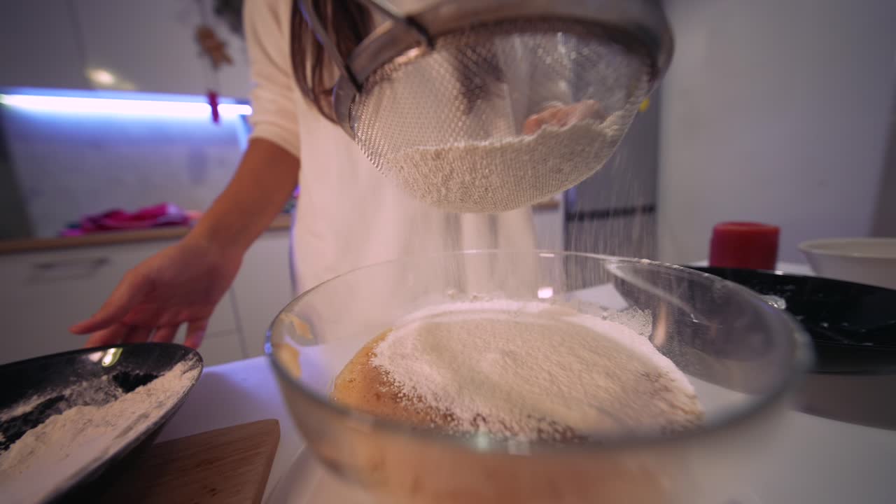 Close-up of Hands Sifting Flour into a Bowl for Baking