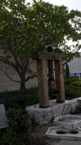 replica reconstruction of a screw olive press used in ancient times to make olive oil - vertical