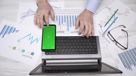 businessman is typing text on a laptop