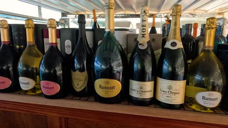 assorted wine bottles on a restaurant shelf