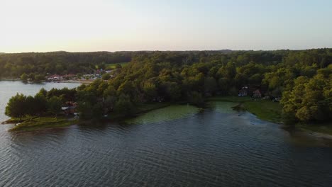 jetty surrounded by forest on the lake of soustons in the french landes at sunset time