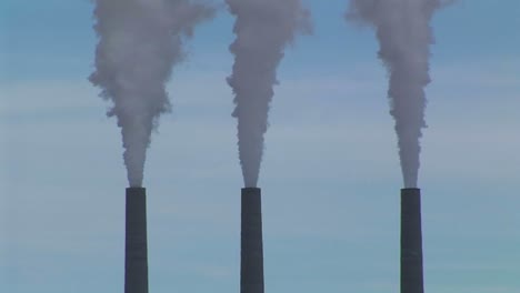 Mediumshot-Of-Three-Smokestacks-Belching-Fumes-In-An-Arizona-Desert