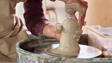 mid section of potter making pot