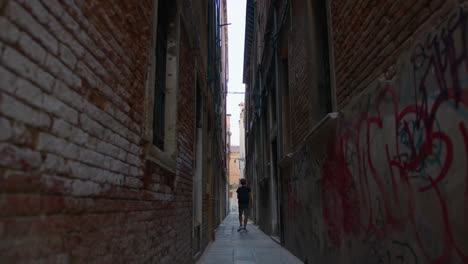 walking through a narrow alley in venice