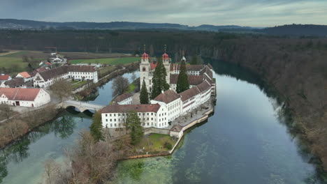 high towers in the historical rheinau monastery church next to a dense forest