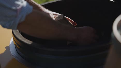 placing-wood-into-outside-BBQ