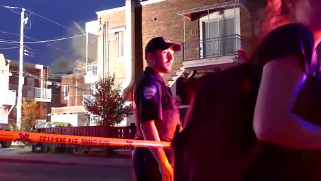 police officer questioning a woman at night crime scene