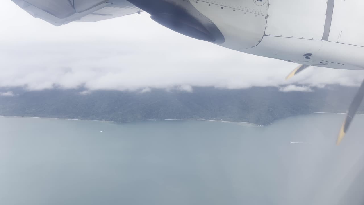 Aerial view from a domestic flight over Colombia captured from the window seat during approach to José Celestino Mutis Airport in Bahía Solano with views of the Pacific Coast