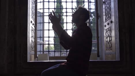 muslim young man praying to allah.