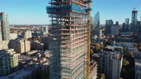 aerial views of a modern skyscraper construction project showcasing progress and urban development amidst a vibrant city landscape