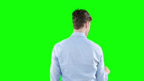 caucasian man back to camera on green background