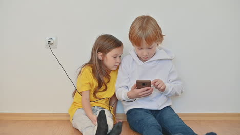 little boy and girl with a smartphone using an app