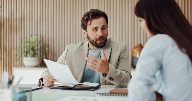 Professional Man Discussing Documents with Colleague in Modern Office