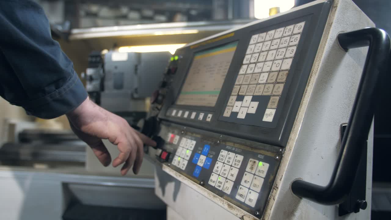 Industrial Worker Operating CNC Machine