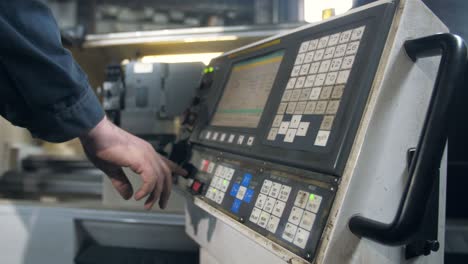 industrial worker operating cnc machine