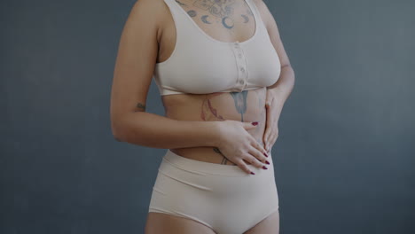woman in undergarments with tattoos