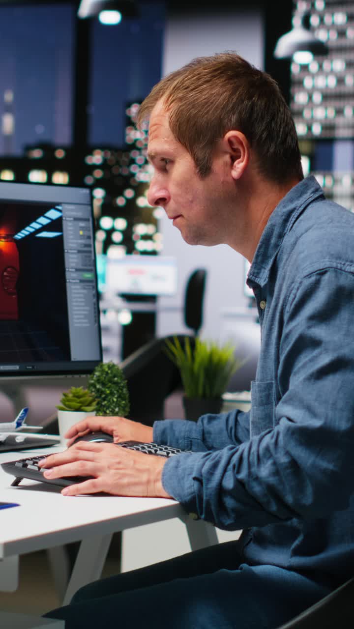 Vertical Video Male IT engineer uses AI techniques to create video game and a turbine
