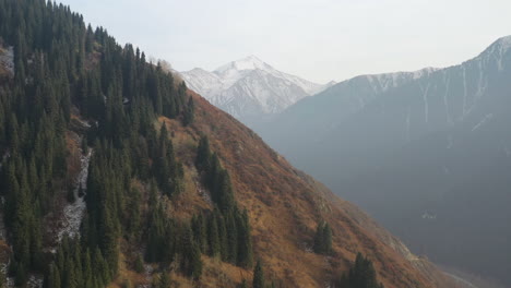 cinematic revealing drone footage of the trans-ili alatau mountains in kazakhstan in the distance