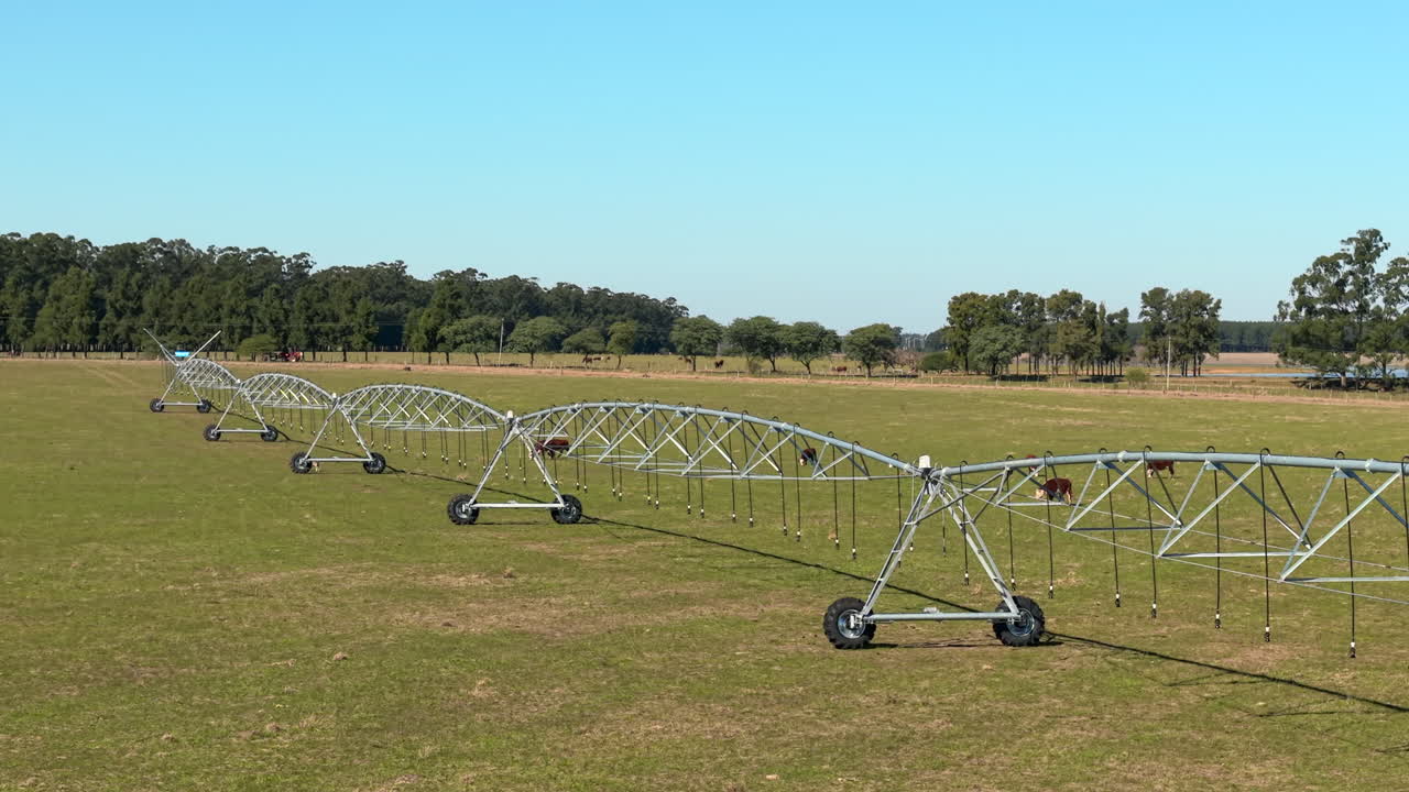 Angled drone view of large irrigation system technology in operation across rural farmland