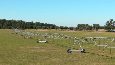 angled drone view of large irrigation system technology in operation across rural farmland