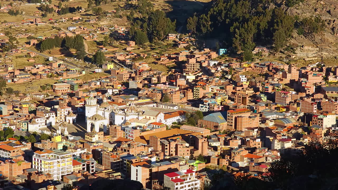 Experience a breathtaking pan shot of Copacabana, Bolivia, at dusk, as seen from the top of Cerro Calvario
