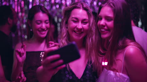 friends taking a selfie at a nightclub