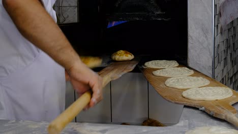 baking bread, baking bread putting raw dough oven