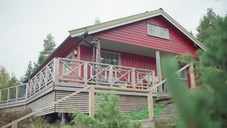 wooden cabin surrounded with green trees at the countryside of norway