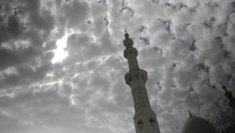 mosque minaret in the uae with clouds in the background