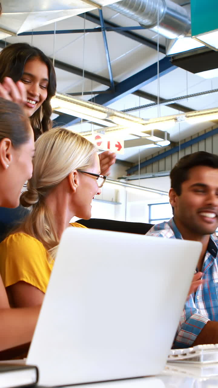 Businesspeople interacting and applauding