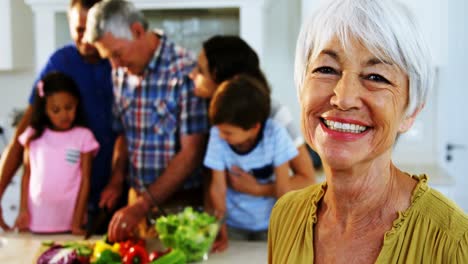 Portrait-of-senior-woman-smiling-in-kitchen