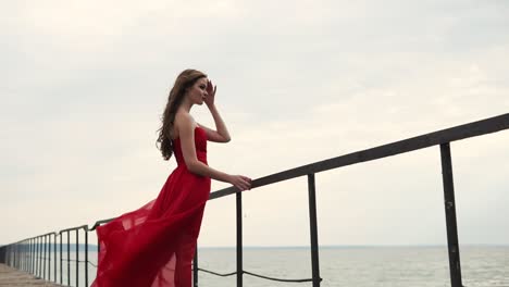 woman in a red dress on a pier