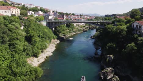 aerial view towards lučki most mostar city bridge and stunning scenic blue water of neretva river, bosnia and herzegovina