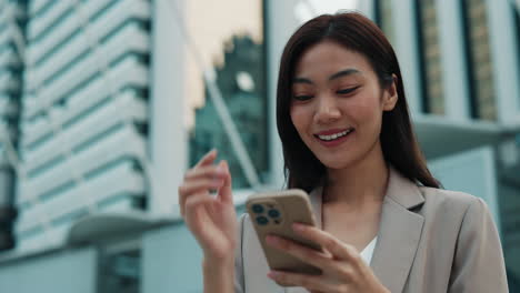 business woman using smartphone in city
