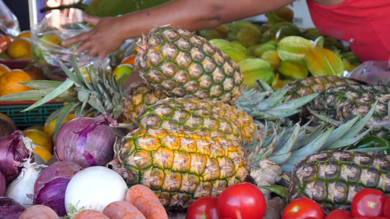 Farmer's market stall sin the pacific showing tropical fruit and other produce