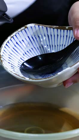 person pours water into a bowl