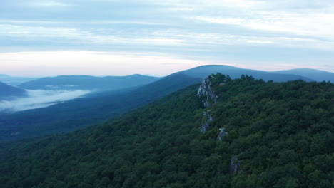 An-aerial-shot-of-Big-Schloss,-Great-North-Mountain-and-the-Trout-Run-Valley-at-dawn-in-the-summer,-located-on-the-Virginia-West-Virginia-Border-within-the-George-Washington-National-Forest