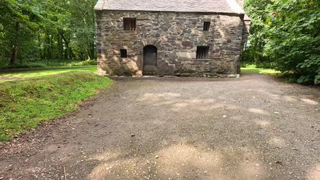 stone building surrounded by lush green trees