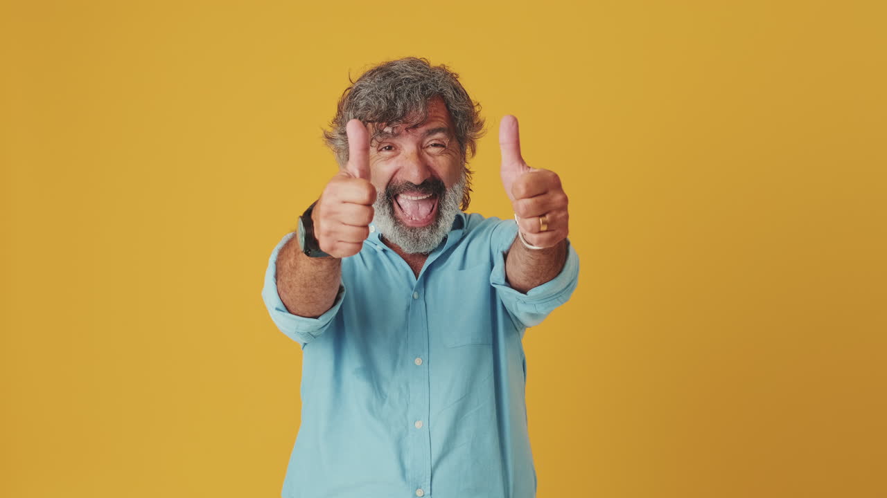 Happy Mature Man Smiling and Giving Thumbs Up