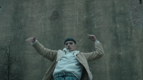 Professional-Male-Dancer-Dancing-in-front-of-Old-Concrete-Building